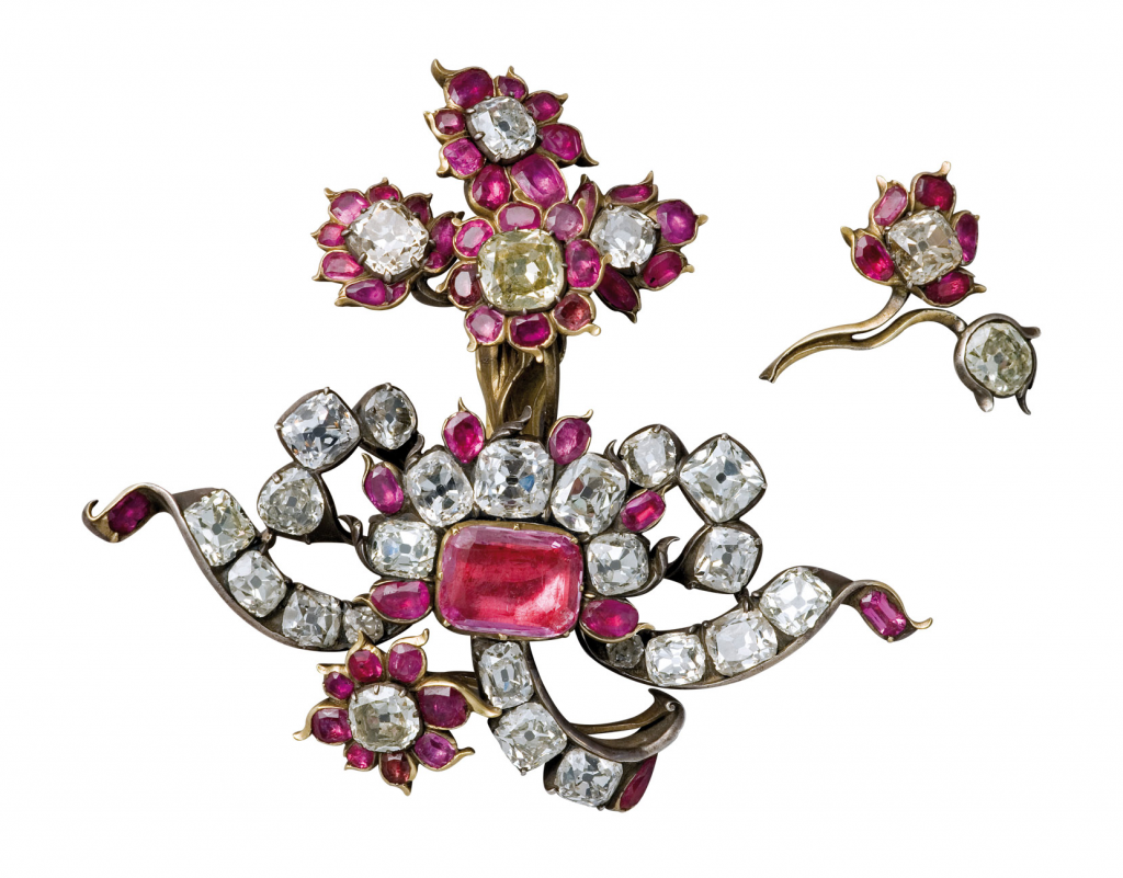 Aguja de oro y plata con diamantes, granates y un topacio rosa.